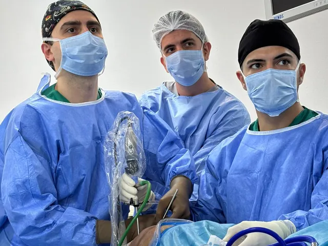 A surgical team in operating room attire during an operation