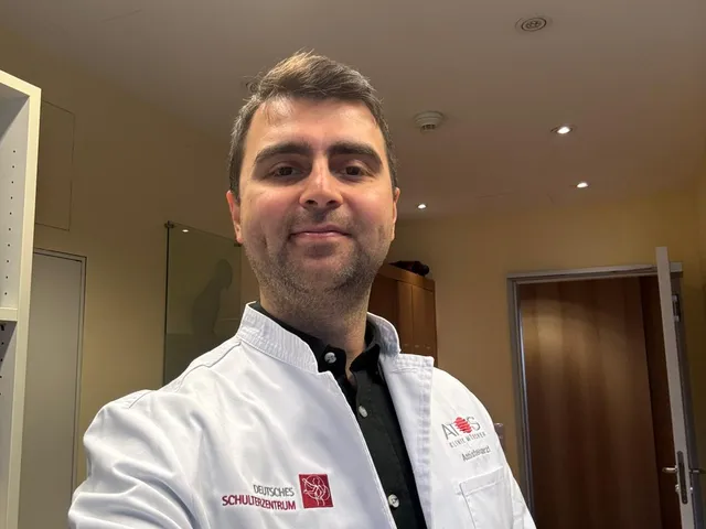 Dr. Mehmet Kaymakoğlu in his white coat in a consultation room