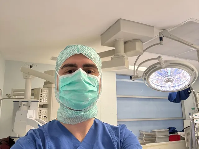 Surgeon in sterile scrubs and mask in the operating room