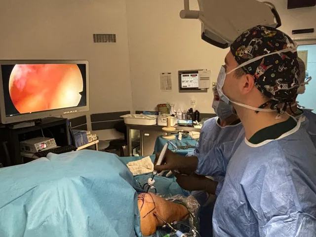 Surgeon performing arthroscopic shoulder surgery in the operating room